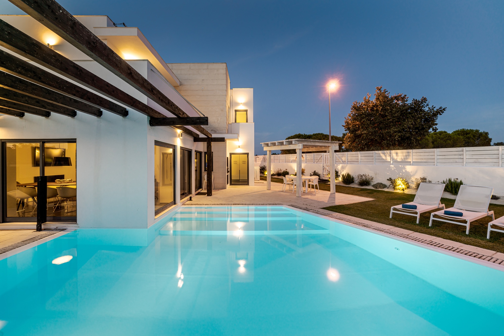 Modern house with garden swimming pool and wooden pergula